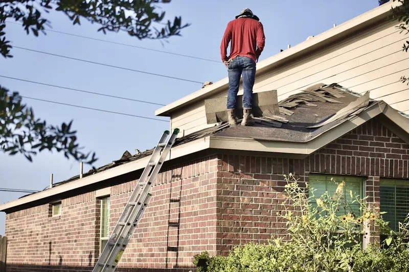 Professional roofer working on a residential roof in Jamesville